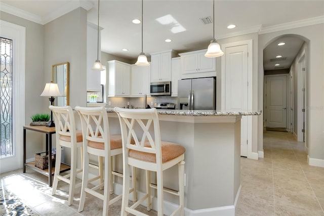 kitchen featuring white cabinets, stainless steel appliances, and a healthy amount of sunlight