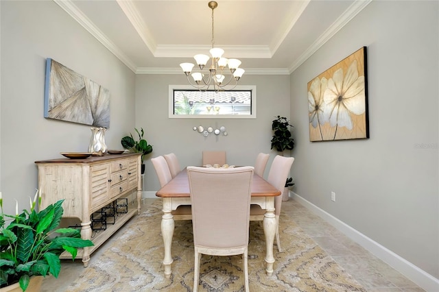 dining space featuring a chandelier, a raised ceiling, and ornamental molding