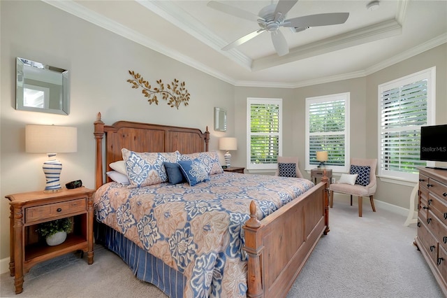 bedroom featuring ceiling fan, a raised ceiling, light colored carpet, and crown molding