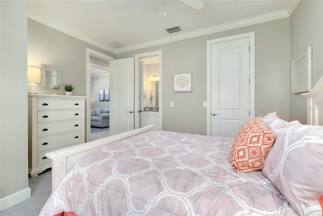 bedroom with ceiling fan, light colored carpet, crown molding, and ensuite bath