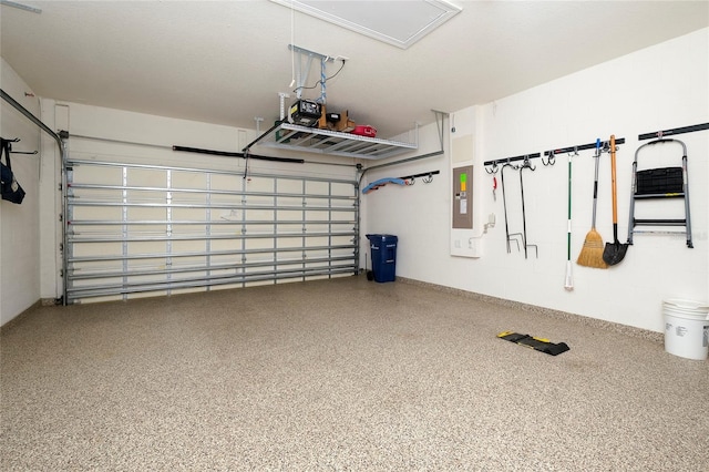 garage featuring electric panel and a garage door opener