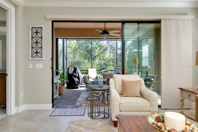 living room with tile patterned floors, ceiling fan, and ornamental molding