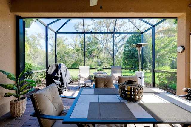 view of patio featuring area for grilling and glass enclosure