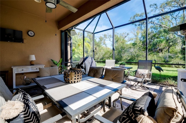 view of patio featuring ceiling fan, a lanai, and exterior kitchen