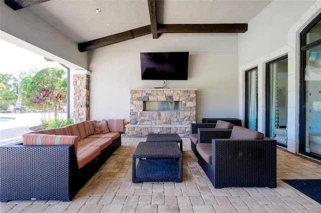 view of patio featuring an outdoor living space with a fireplace