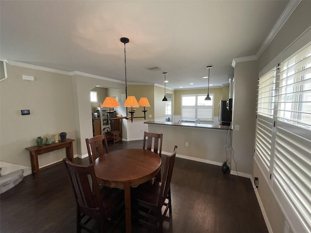 dining area featuring dark hardwood / wood-style floors and crown molding