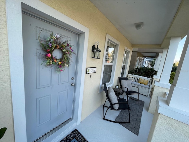 property entrance with stucco siding