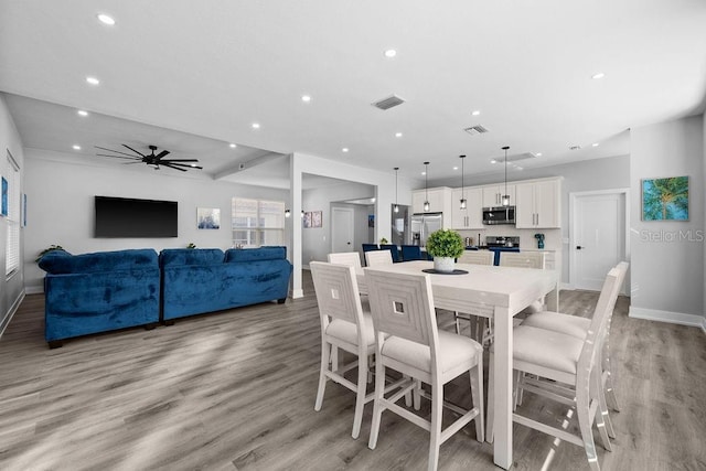 dining room featuring ceiling fan and light hardwood / wood-style floors