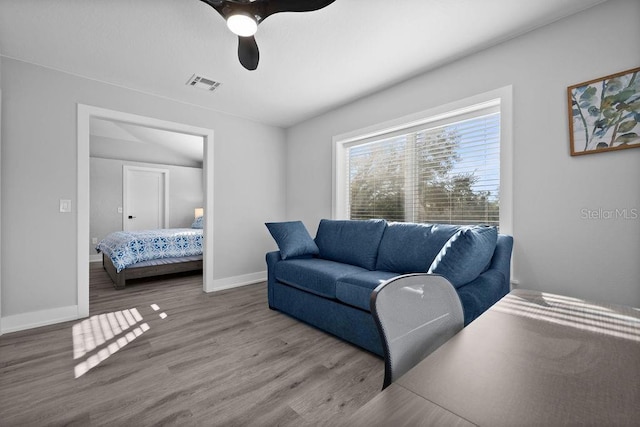 living room with hardwood / wood-style floors and ceiling fan