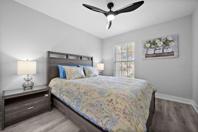 bedroom featuring ceiling fan and hardwood / wood-style flooring