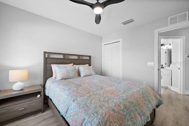 bedroom with ceiling fan, a closet, and light hardwood / wood-style flooring