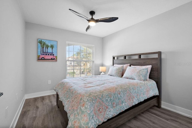 bedroom with dark hardwood / wood-style floors and ceiling fan