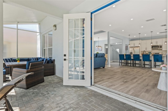 entryway with dark hardwood / wood-style floors and vaulted ceiling