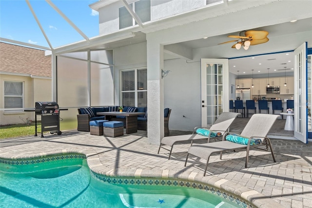 view of swimming pool featuring a lanai, outdoor lounge area, a patio area, and grilling area