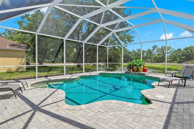 view of swimming pool featuring a patio and a lanai