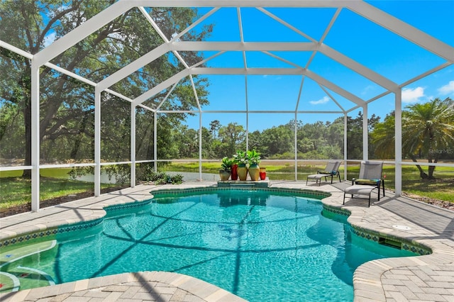 view of pool featuring glass enclosure and a patio