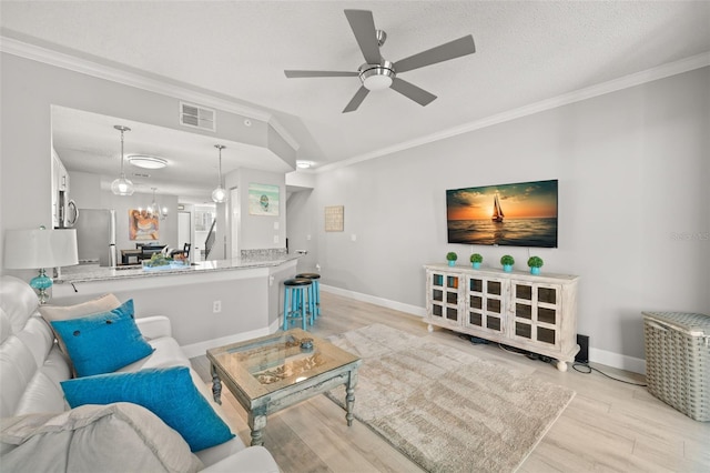 living room featuring vaulted ceiling, ornamental molding, visible vents, and light wood-style floors