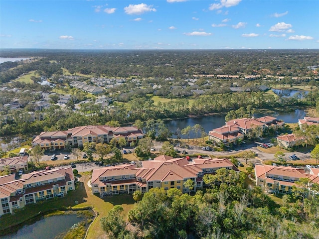 drone / aerial view with a water view and a residential view