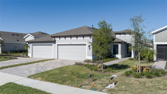 view of front of property featuring a garage and a front yard