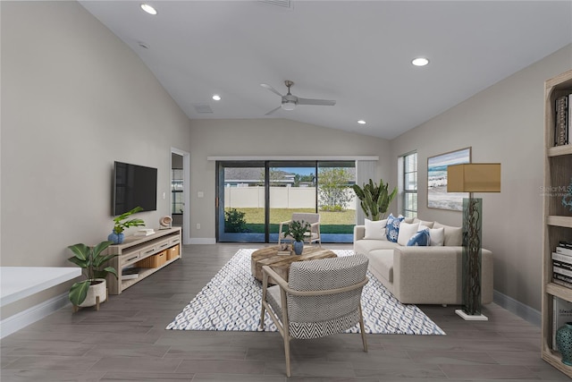 living room featuring ceiling fan and lofted ceiling