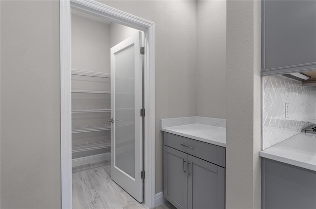 bathroom with vanity and backsplash