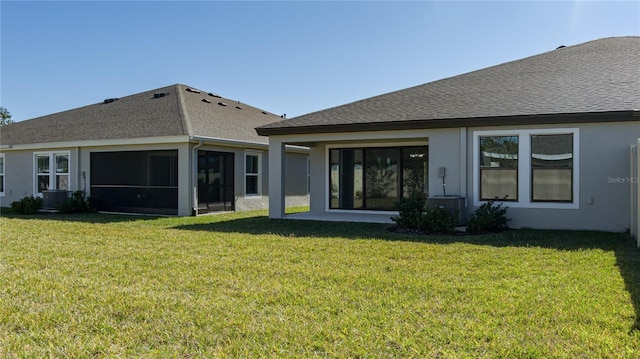 back of house featuring a sunroom and a yard