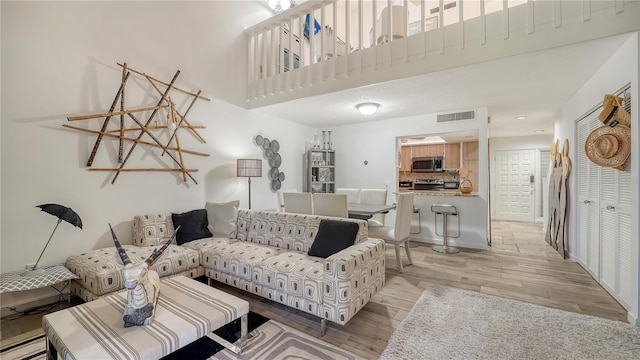 living room featuring light hardwood / wood-style flooring and baseboard heating