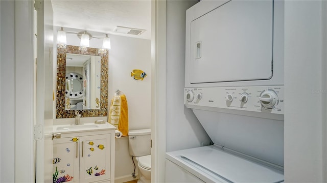 clothes washing area featuring stacked washer / drying machine and sink