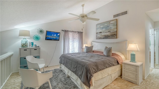 carpeted bedroom featuring a textured ceiling, ceiling fan, and lofted ceiling