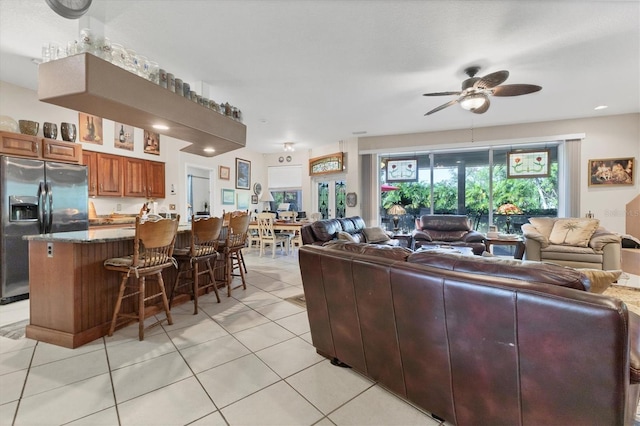 living room featuring ceiling fan and light tile patterned flooring