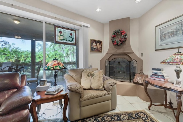 living area featuring a fireplace and light tile patterned flooring