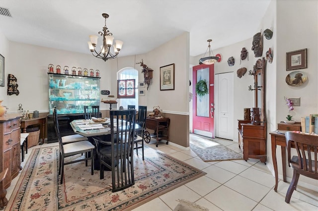 tiled dining area with a chandelier