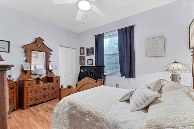 bedroom featuring ceiling fan, light wood-type flooring, and a closet