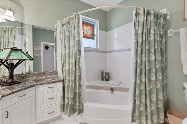 bathroom featuring shower / bath combo and vanity