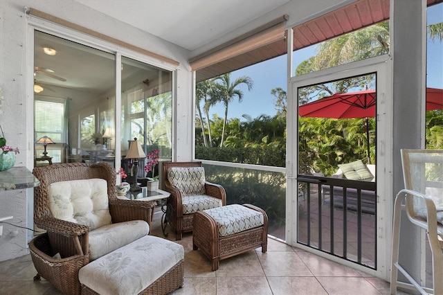 sunroom / solarium featuring ceiling fan