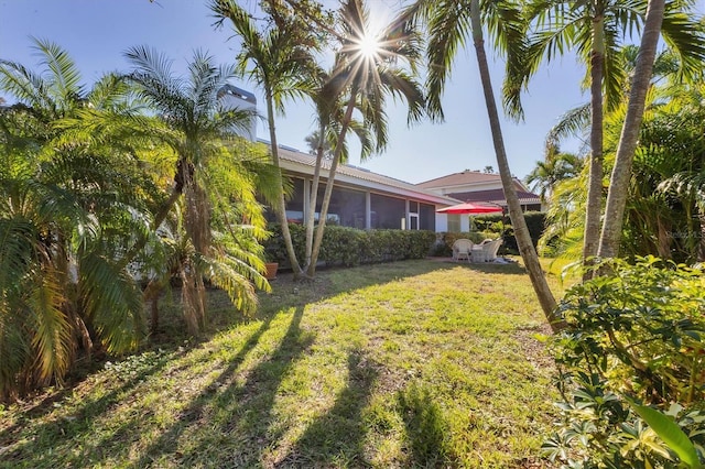 view of yard with a sunroom