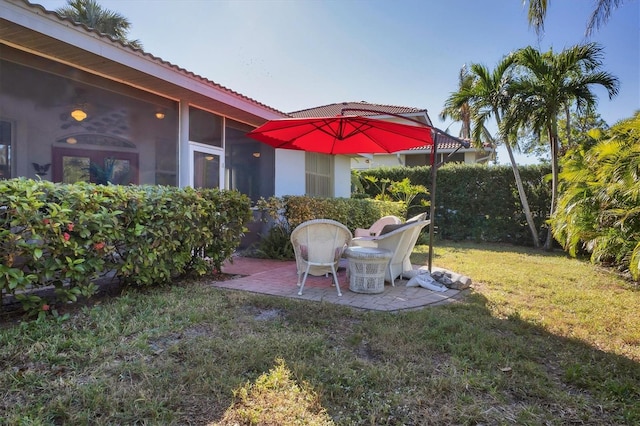 view of yard featuring a sunroom and a patio area