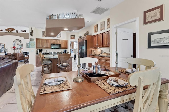 dining area with light tile patterned floors