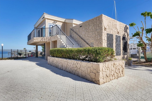 view of side of home with a balcony