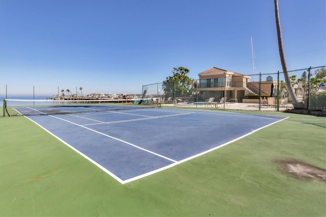 view of sport court featuring a water view and basketball court