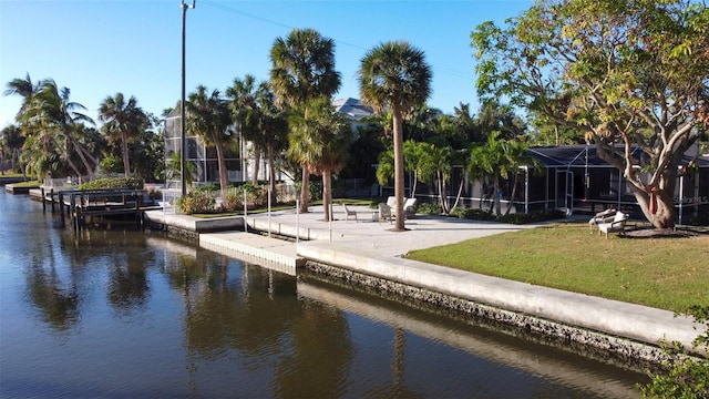 view of community featuring a lawn and a water view