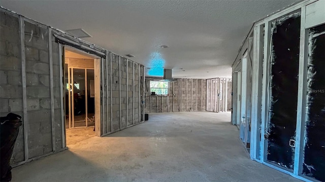 interior space with concrete flooring and a textured ceiling