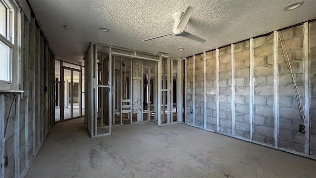 misc room with ceiling fan and a textured ceiling