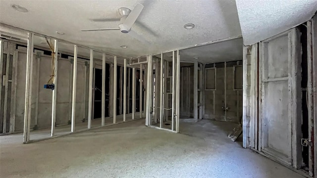 miscellaneous room with ceiling fan and a textured ceiling