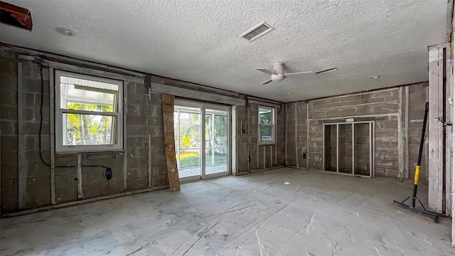 misc room with ceiling fan and a textured ceiling