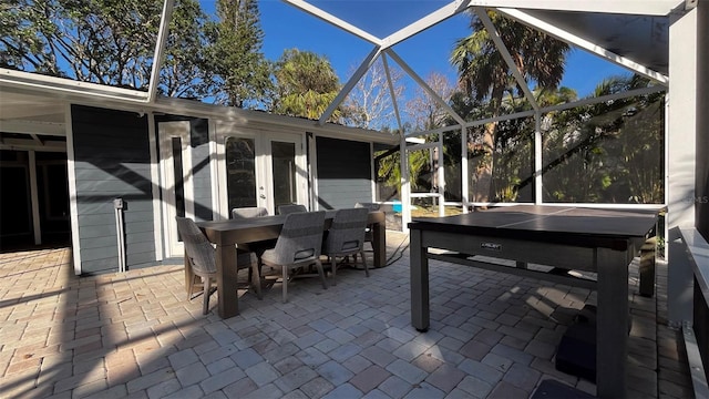 view of patio featuring a lanai and french doors