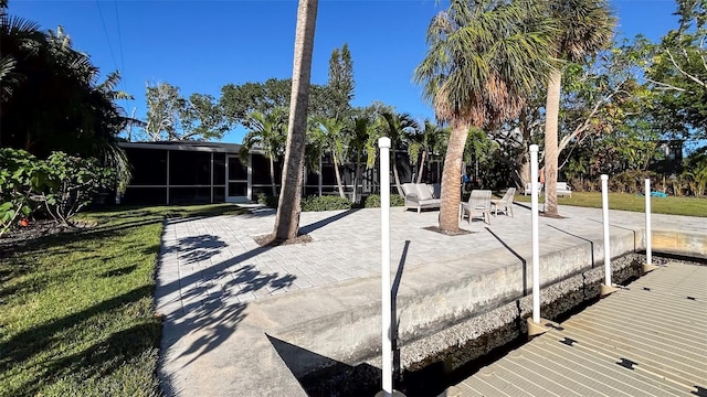 view of community with a lawn and a patio area