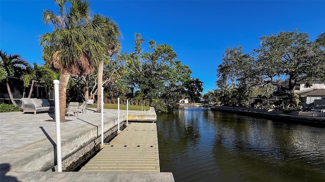 view of dock with a water view and a patio area