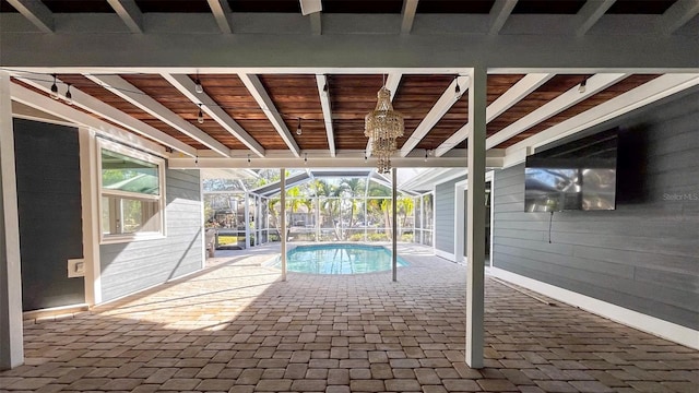 view of swimming pool with glass enclosure and a patio