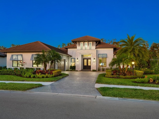 view of front of house with a front yard and french doors